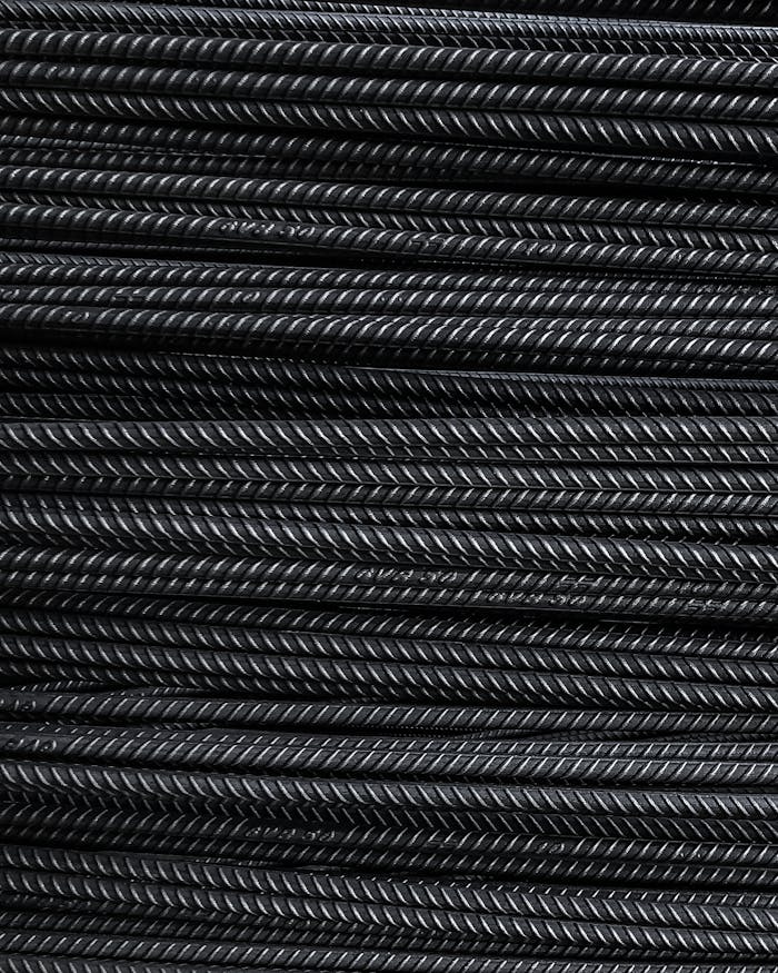 Close-up view of neatly stacked metal rebars showcasing detailed texture and industrial feel.